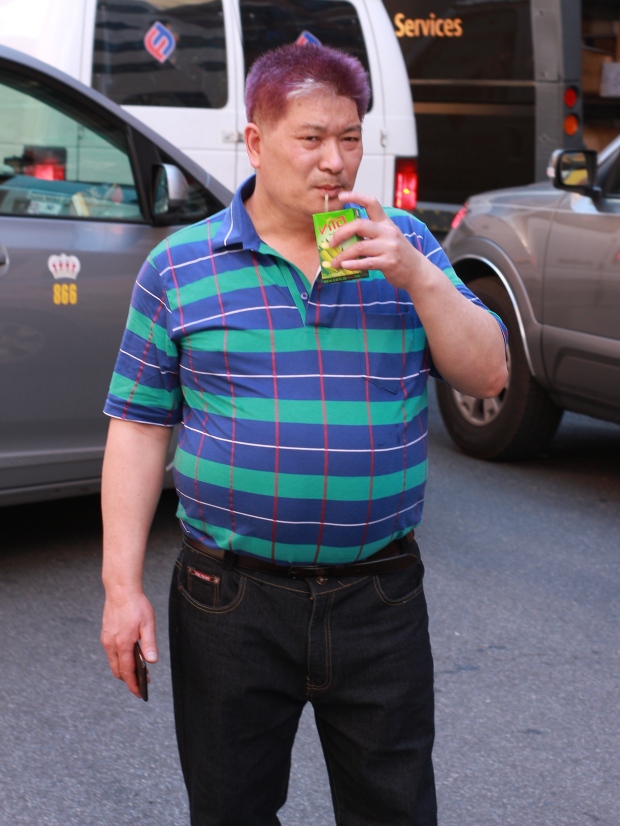 man drinking juice in chinatown, new york