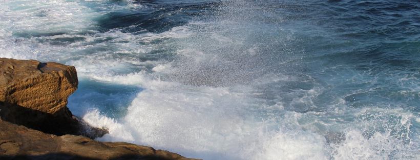 sea spray and waves on rocks